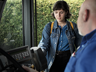 Jeune femme qui paie son titre d'autobus avec paiement sans contact