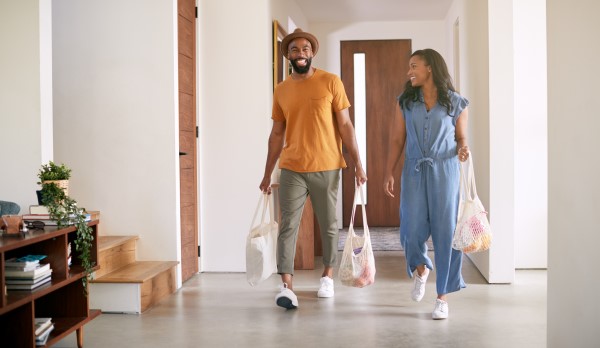 Couple returning home with grocery bags