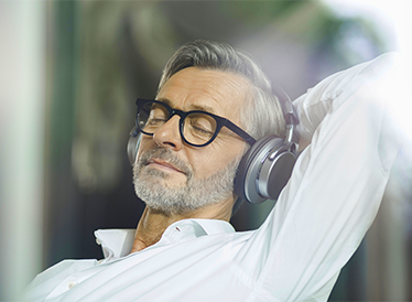 A relaxed man with headphones on