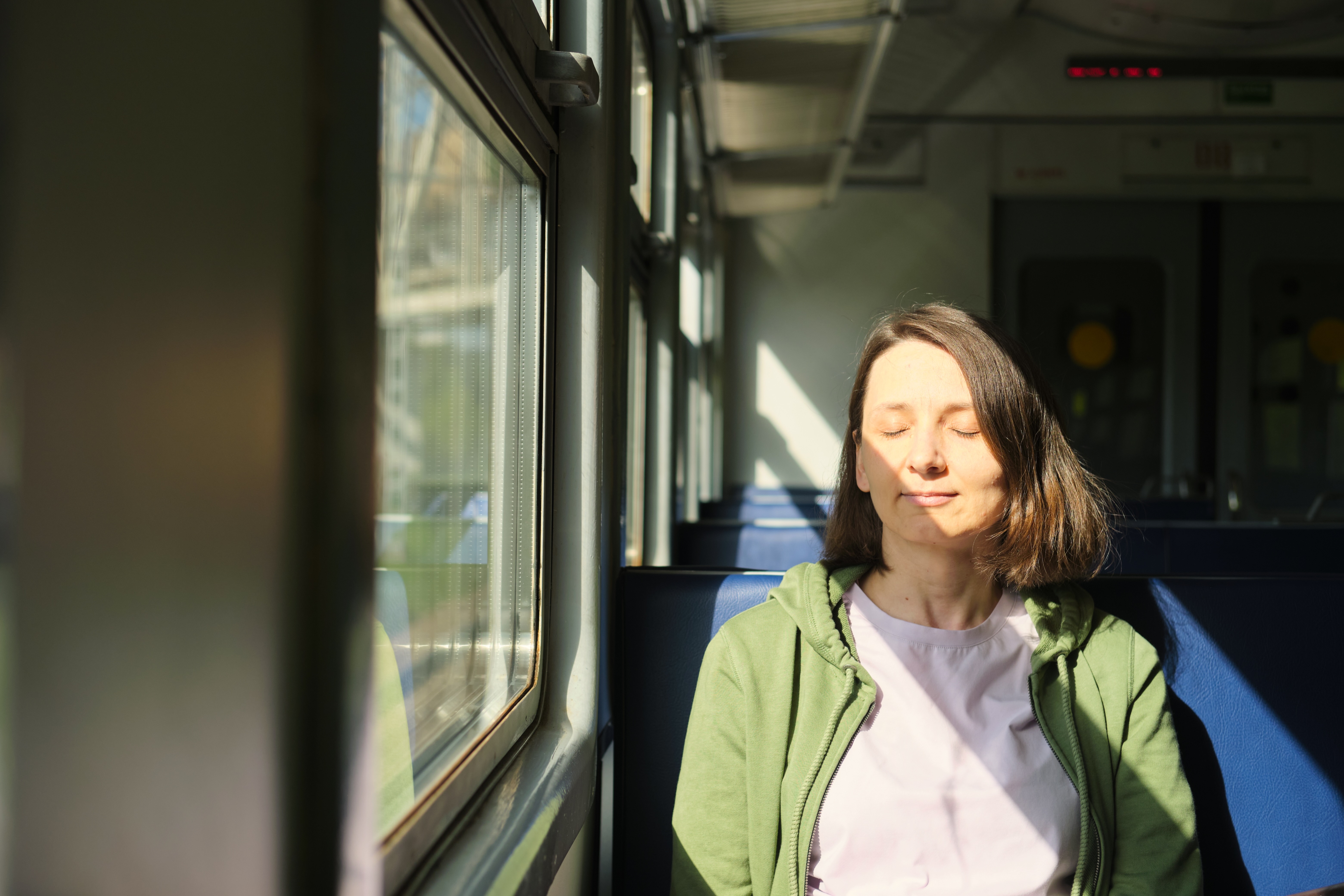 Woman meditating in a train 