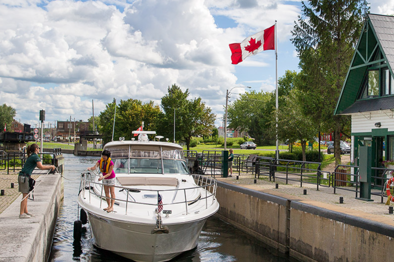 Two people docking a boat at the lock